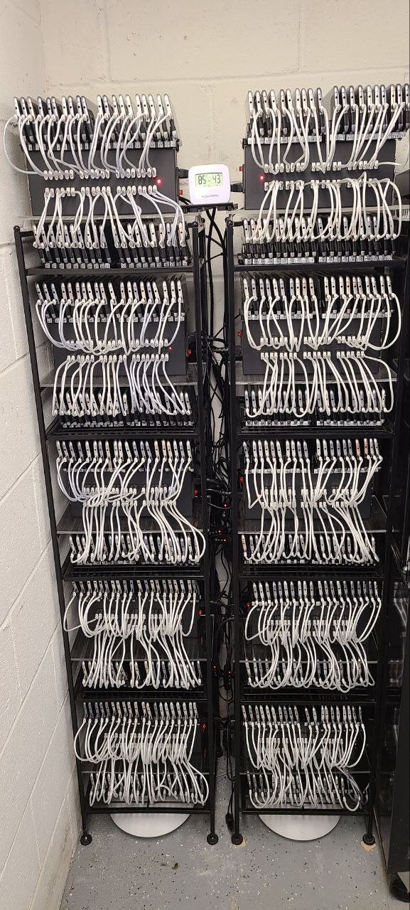 A live PocketProxy mobile proxy phone farm, racks of Android phones, each running as a mobile proxy node on a real carrier IP